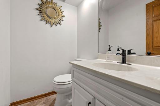 Practical comforts on the main level include a powder room.