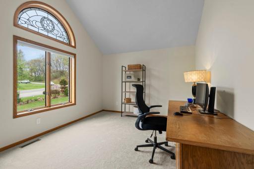 A versatile main-level office with vaulted ceilings can easily serve as an additional bedroom.