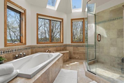 Multiple windows frame stunning lake views, complemented by skylights for added natural light.