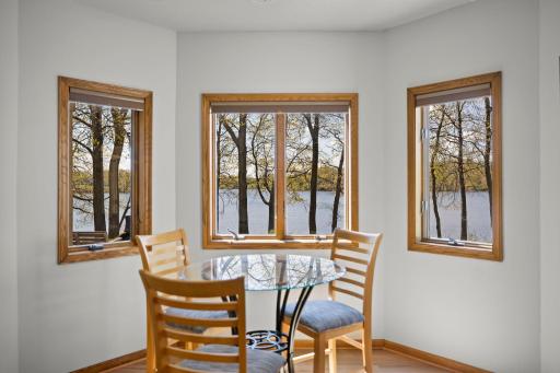 A cozy den with bay windows offers serene views.