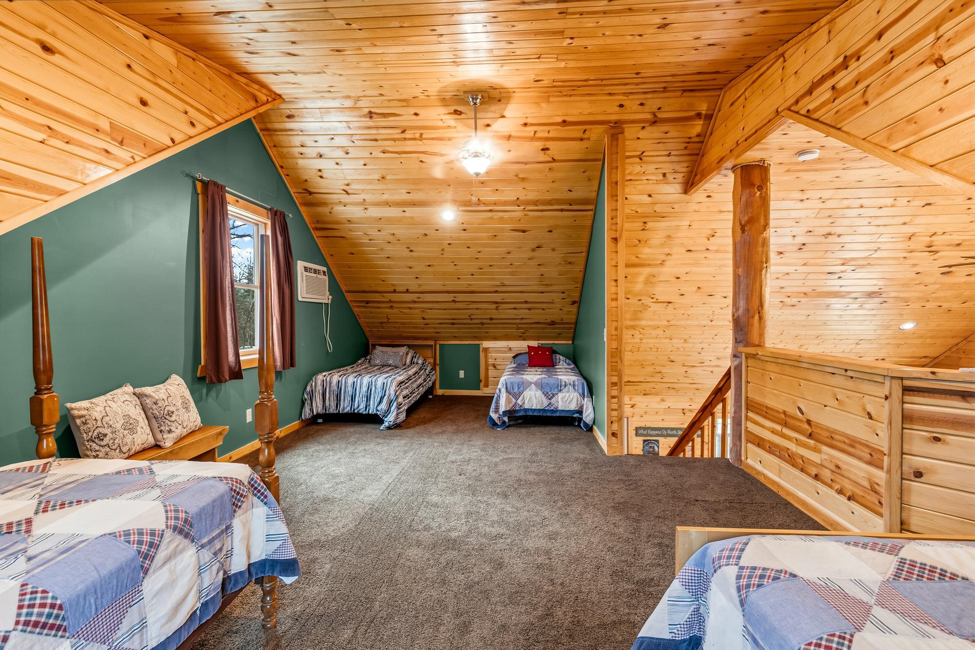 Currently the loft space has four single beds. There is also a wall unit air conditioner.