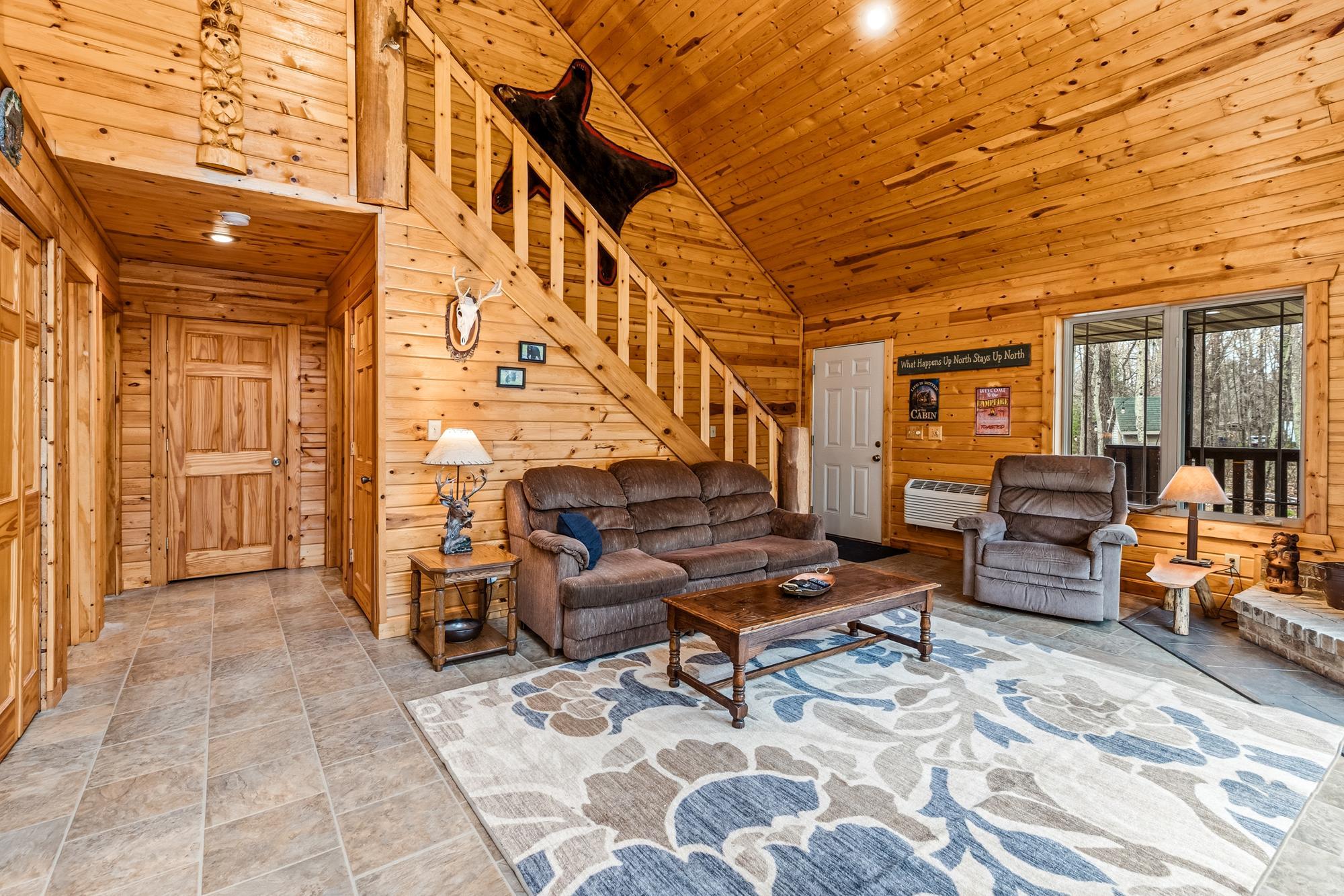 6-panel solid doors. Open concept with the living room, eat-in kitchen and loft space. Notice the white ductless mini-split by the front door. That is both an A/C and a heater.