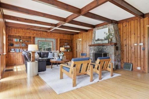 Spacious living room with wood beams, stone fireplace