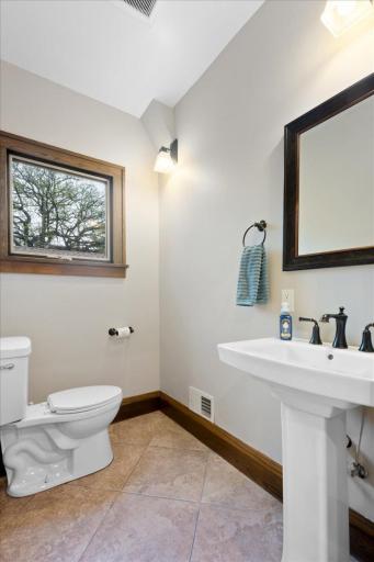 Convenient main-level half bath located just off the kitchen, dining area, and rear entryâfeaturing clean finishes and easy access for guests.