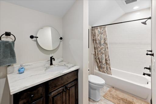 Upper-level full bath with clean finishes and functional layout.