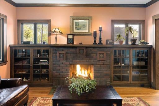 Stunning wood-burning fireplace with classic brick surround and custom built-insâperfect focal point of the home.