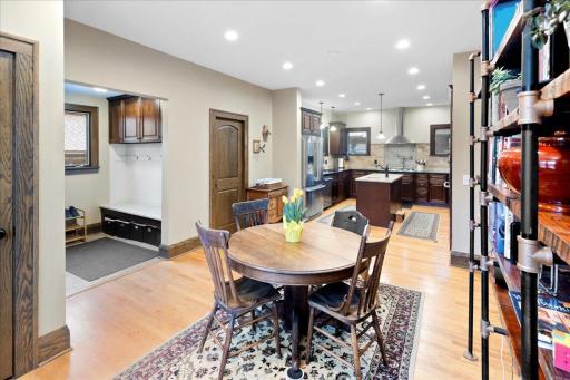 Open-concept informal dining and kitchen with seamless flow, hardwood floors, and abundant natural light. Ideal for everyday living and entertaining.