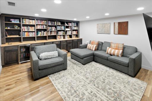 Comfortable and open lower-level living space with ample room for seating and media setup.