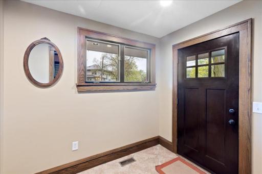 Welcoming front foyer with classic woodwork and natural light, an inviting entry that sets the tone for the homeâs warmth and character.