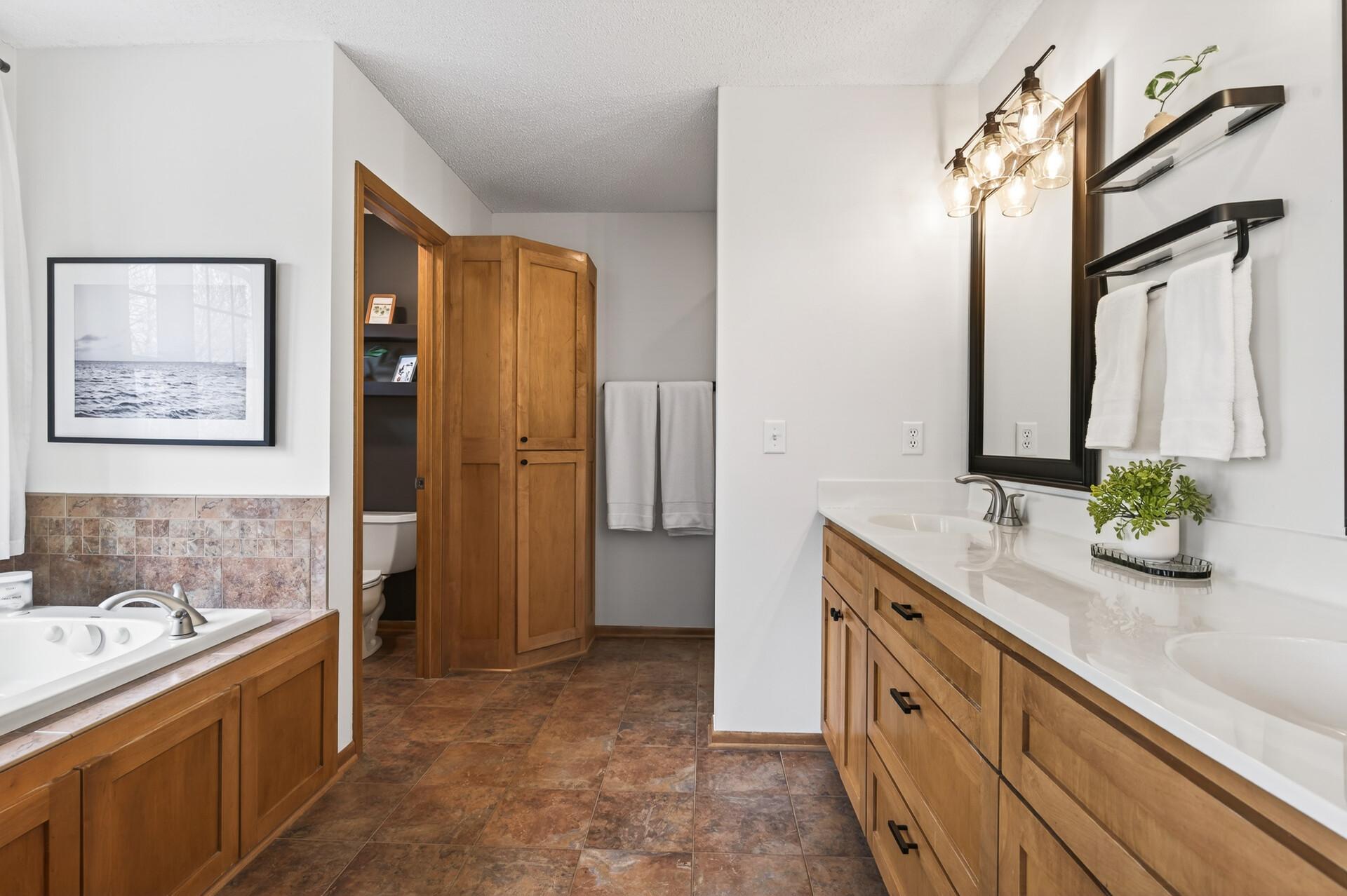 Well-appointed primary bath with double vanity, soaking tub, and separate shower.