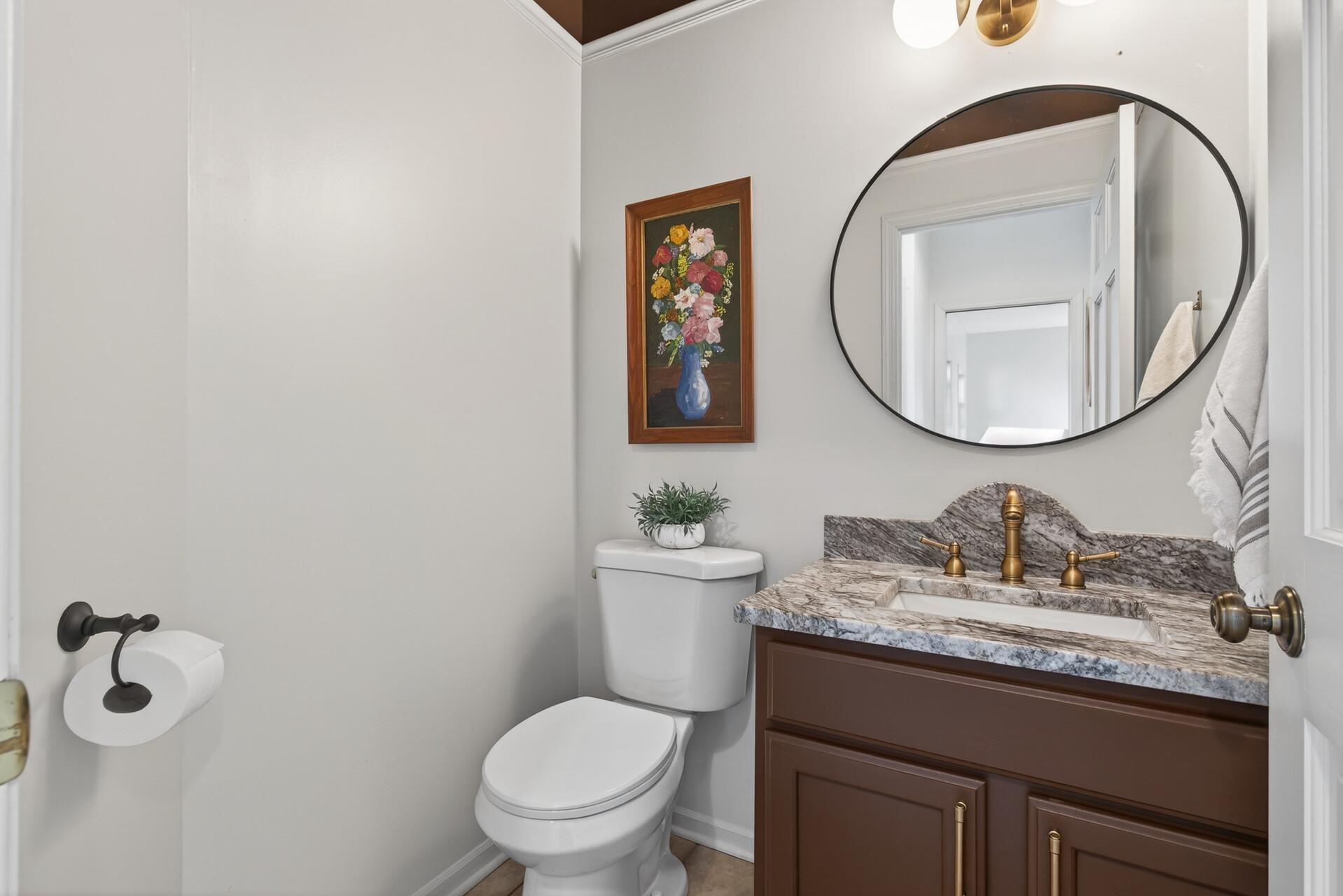 Main floor 1/2 Bath just before Kitchen, new toilet, sink, mirror & lighting