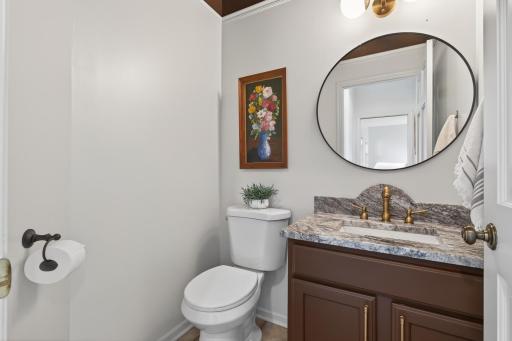 Main floor 1/2 Bath just before Kitchen, new toilet, sink, mirror & lighting