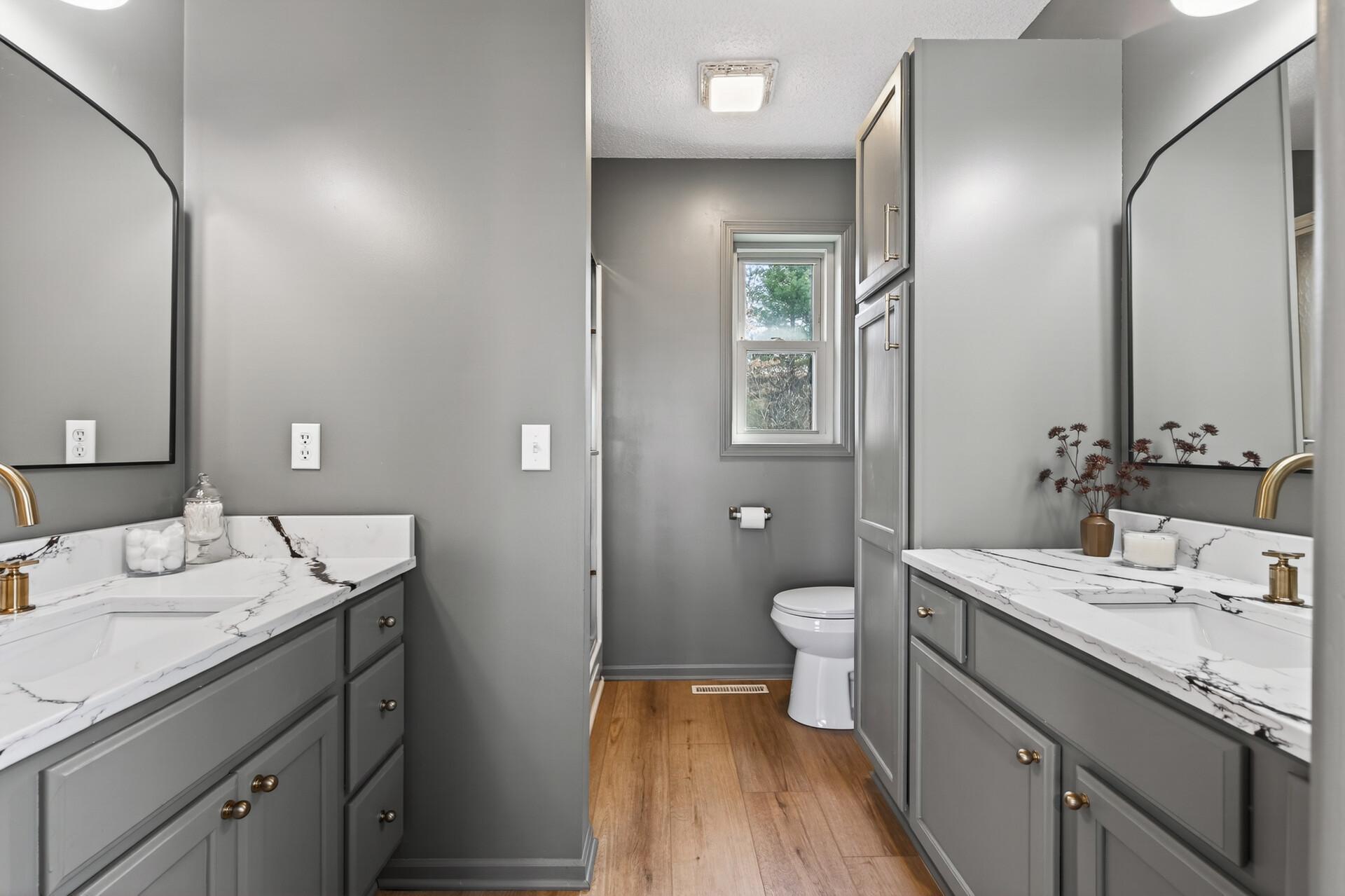Private Primary Bathroom w double vanities, new counters, new mirrors, new toilet, new lighting
