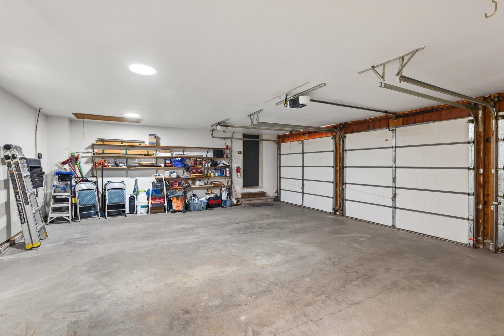 Very spacious heated & insulated 3 Car Garage w 3 separate overhead doors
