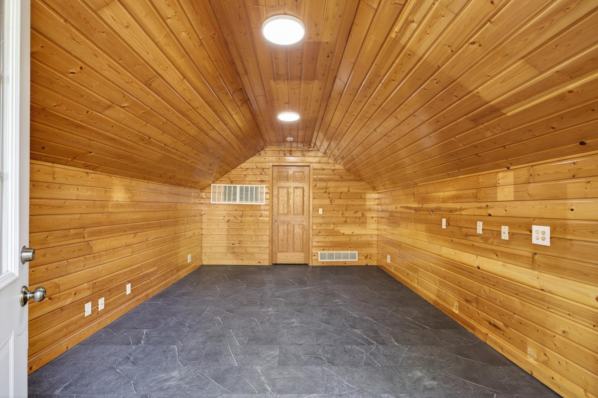 Cedar walls & arched ceiling Bonus Room, new lighting & new floor. Office or man cave or so many possibilities