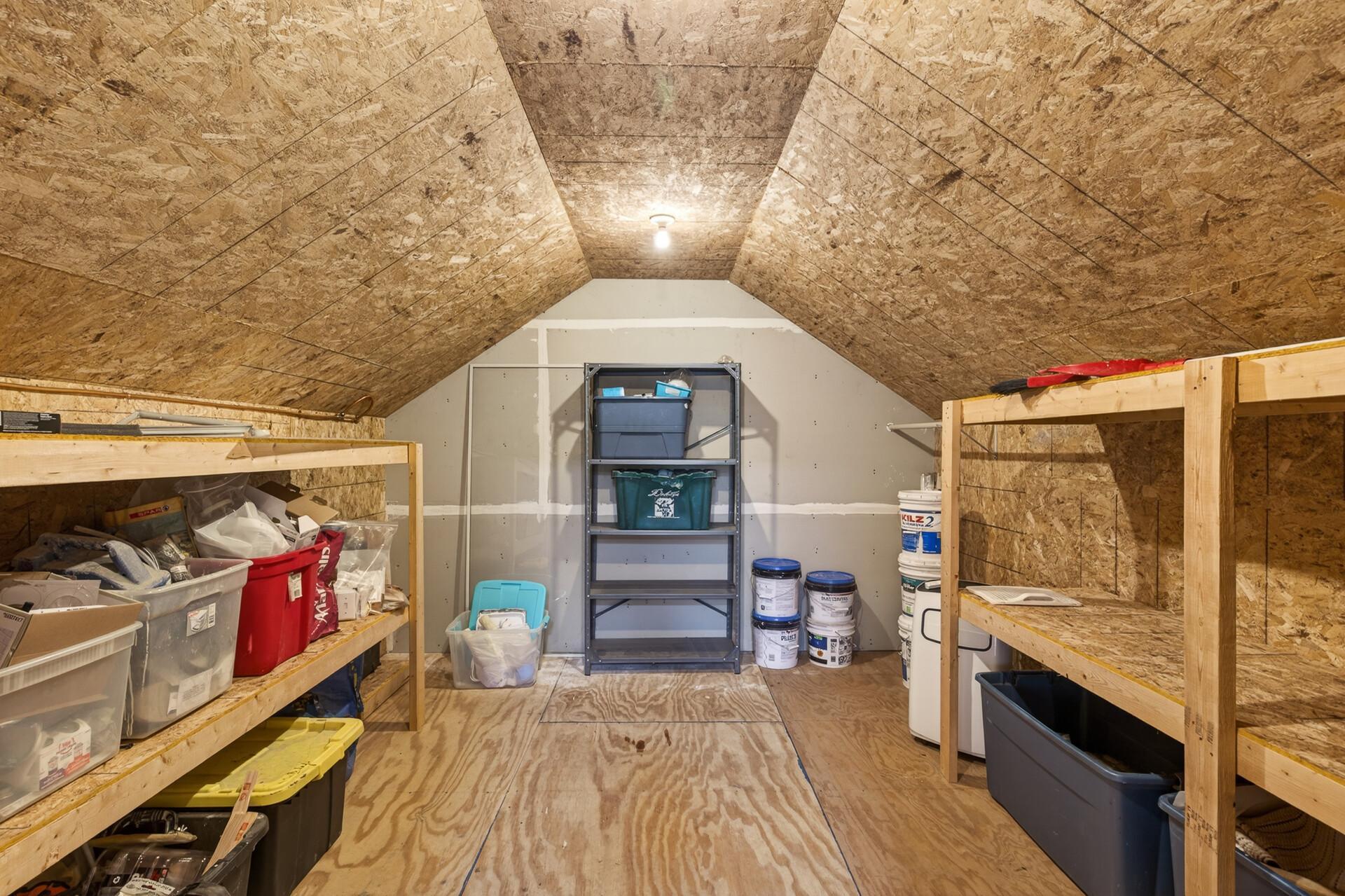 Back of Bonus room is this storage area with shelving, heater & portable A/C