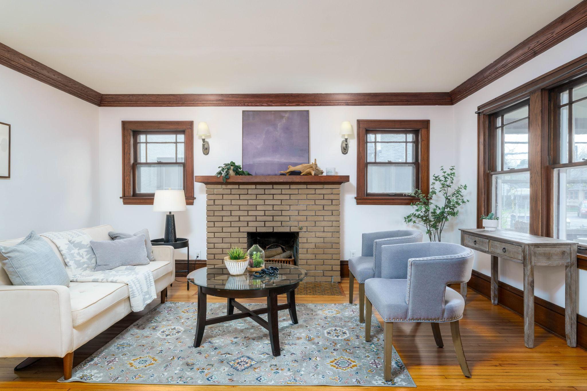 Delightful living room with windows on two sides and gleaming refinished hardwood floors.