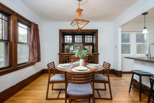 The dining room showcases timeless turn-of-the-century character, complete with a built-in buffet and beautifully refinished hardwood floors.
