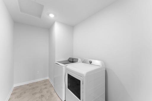 Upper level laundry room which includes washer and dryer