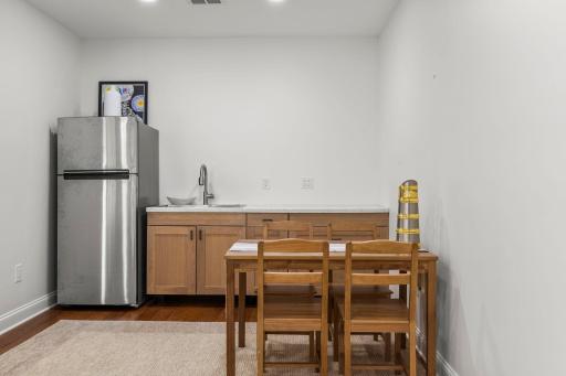 Lower level mini kitchen with new cabinetry, sink and refrigerator!