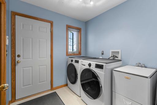 Spacious main level laundry room with laundry sink, and new washer and dryer in 2025!