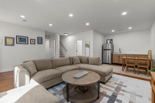 Incredible newly constructed lower level family room/Amusement room with nine foot ceilings, plenty of recessed lighting, new wide plank hardwood floors and even a mini kitchen!