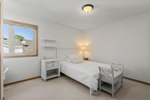 Second bedroom on the upper level with plush carpeting, six panel doors, and even a built-in desk!