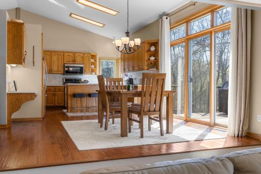 Gorgeous kitchen with vaulted ceilings, wide plank hardwood floors, plenty of cabinetry, quartz countertops (new in 2022), kitchen counter backsplash (new in 2024), and stainless appliances throughout!