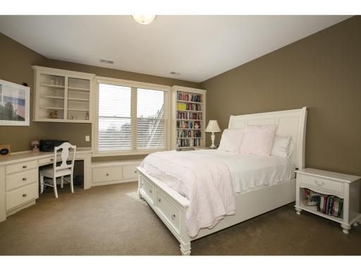 One of four upper level bedrooms complete with builtins and bathroom access