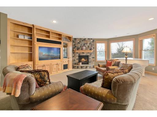 Surround sound speakers, wet bar, pool table & cozy stone front fireplace make this lower level a perfect place to relax or entertain!