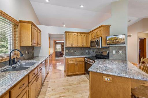 The kitchen has granite countertops and brand new stainless steel appliances