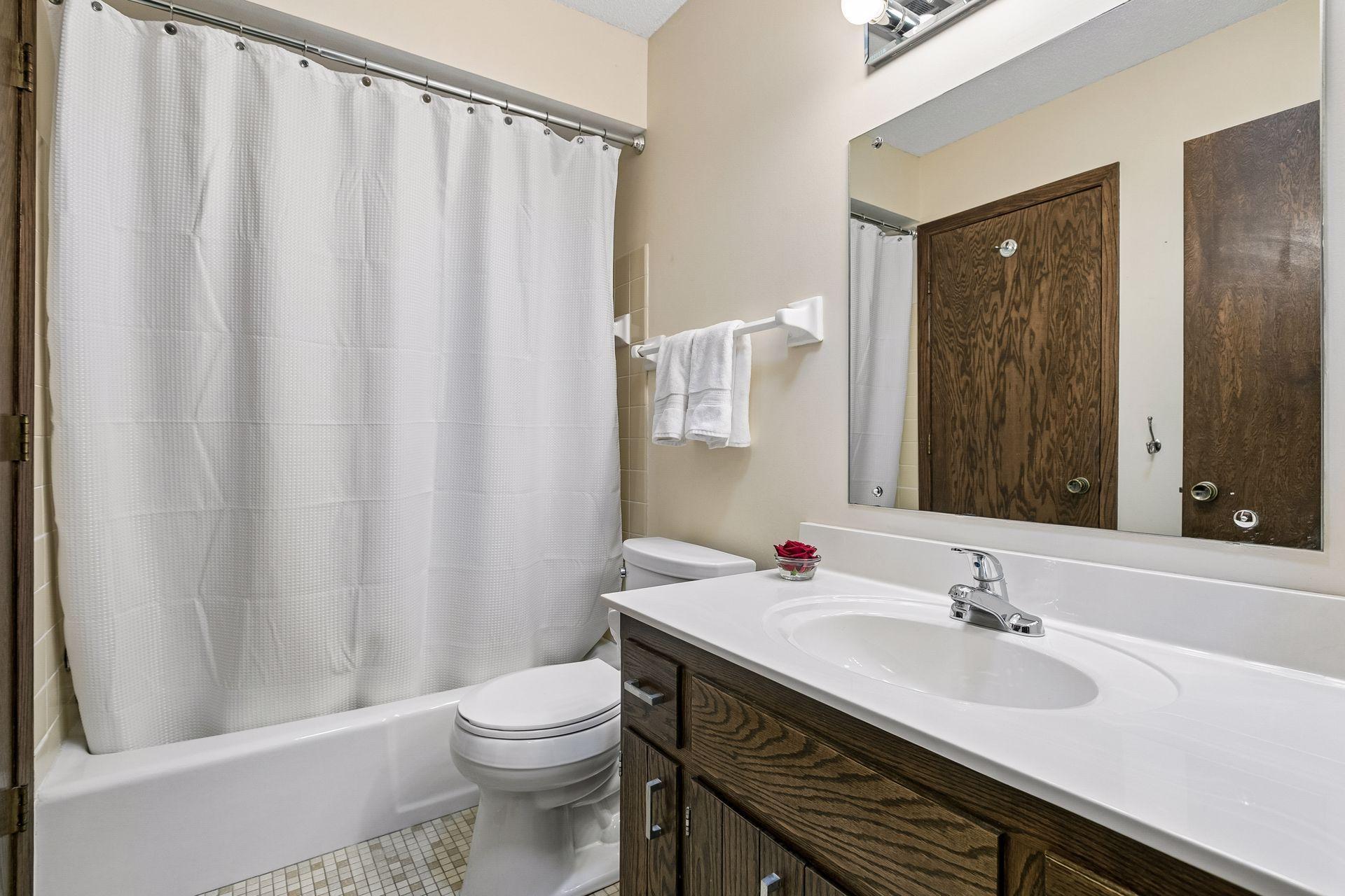 The upper level full bathroom. There is also a door here that leads to the primary bedroom.