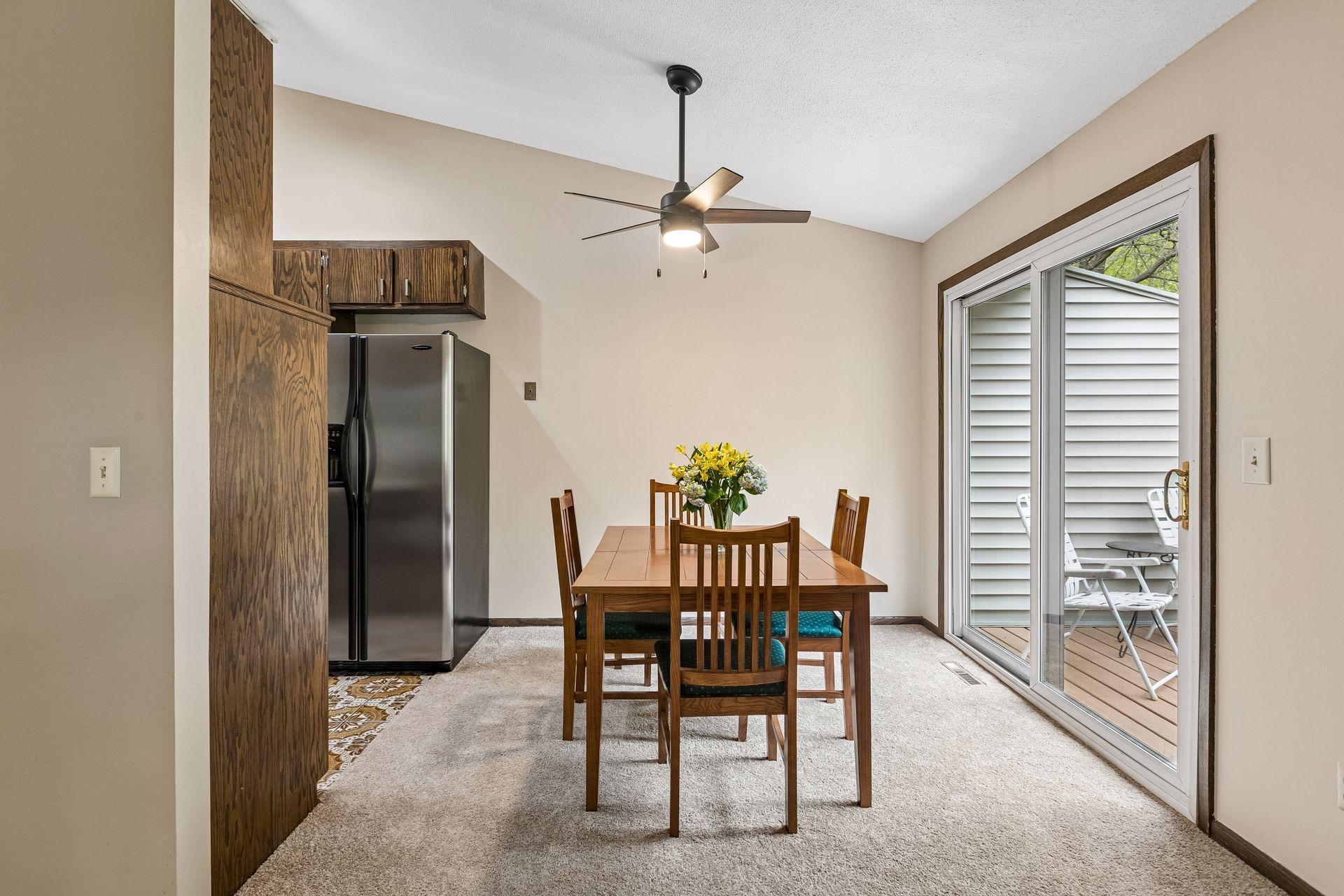 The dining area with a new ceiling fan.