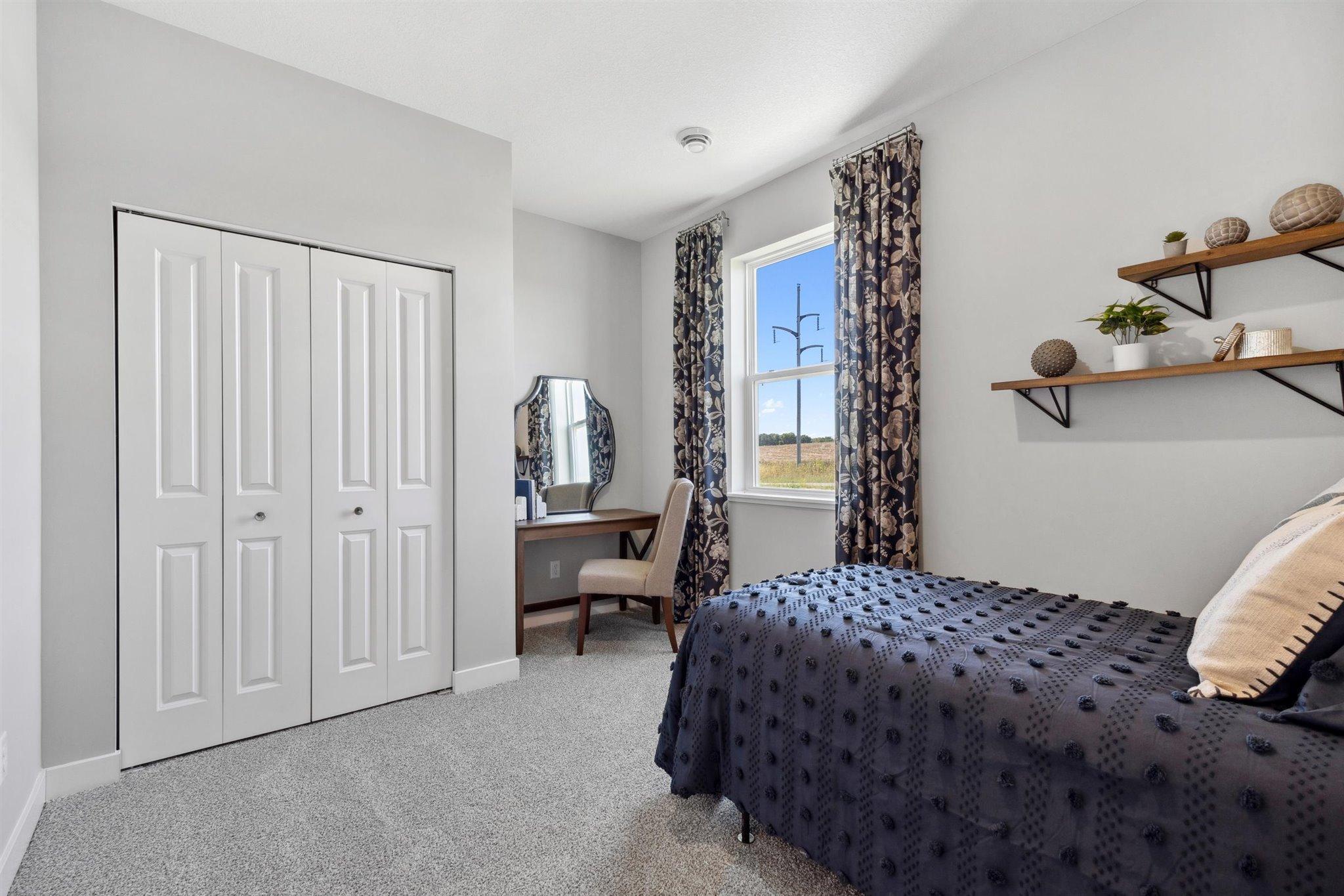 Main Floor Bedroom *Photo is of a past model home, finishes, selections, layout to vary.