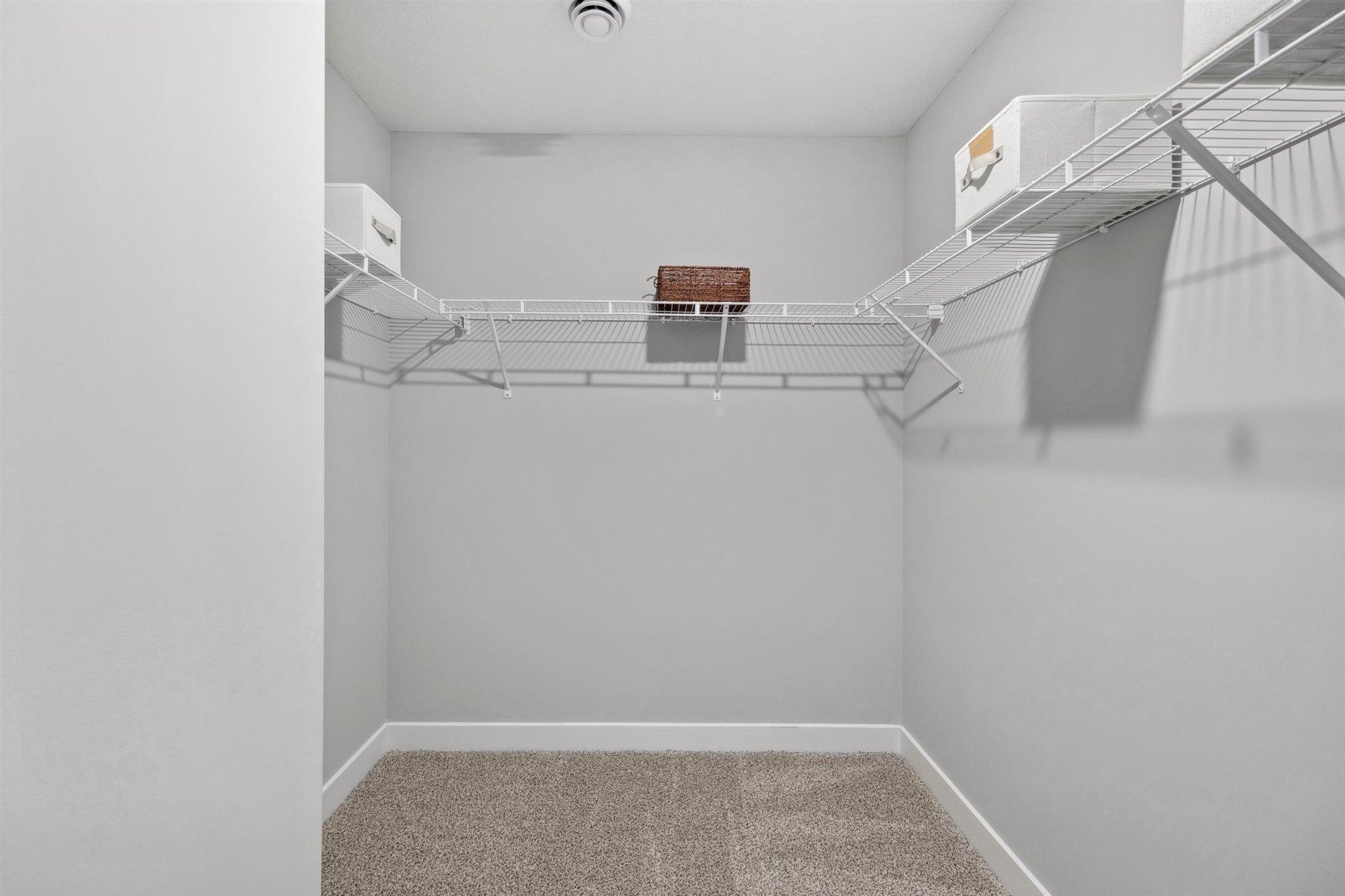2 of 2 closets in the primary bedroom. *Photo is of a past model home, finishes, selections, layout to vary.