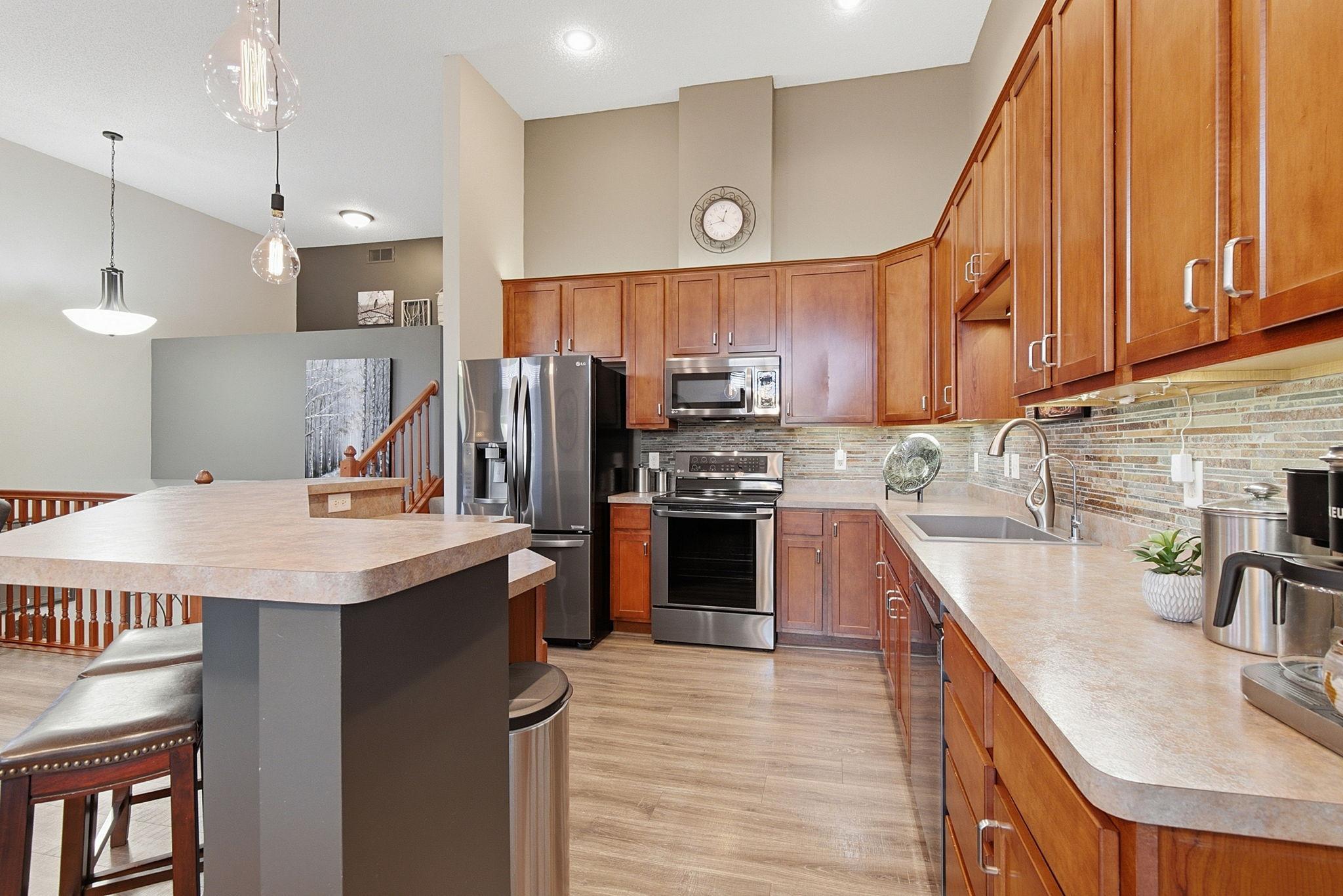 The Kitchen has abundant hardwood cabinets for plenty of storage and stainless steel appliances.