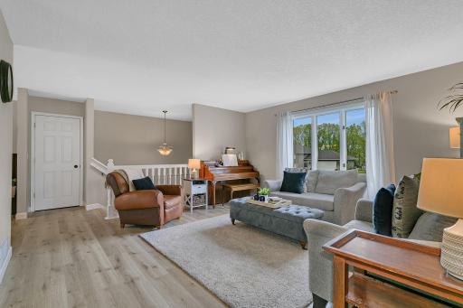 Spacious living room with natural light pouring through the large windows.