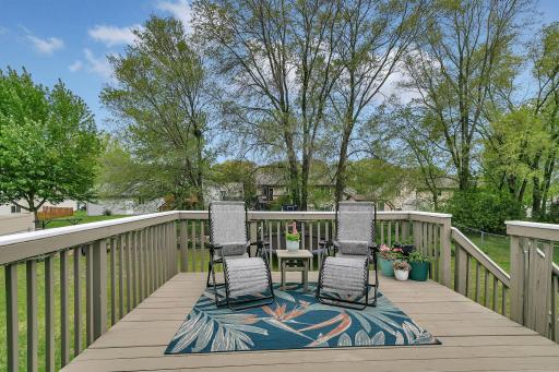 The large deck overlooks the beautiful fenced in backyard