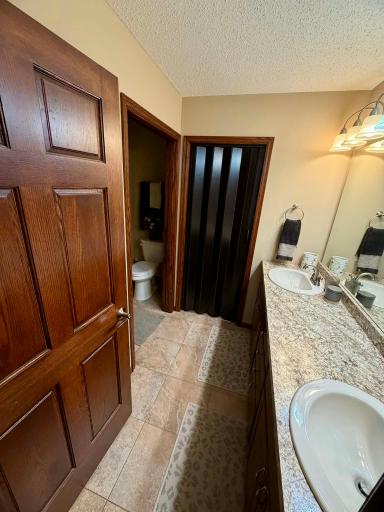 Owner en-suite, pocket door to separate shower area from vanity area. Folding door to walk-in closet