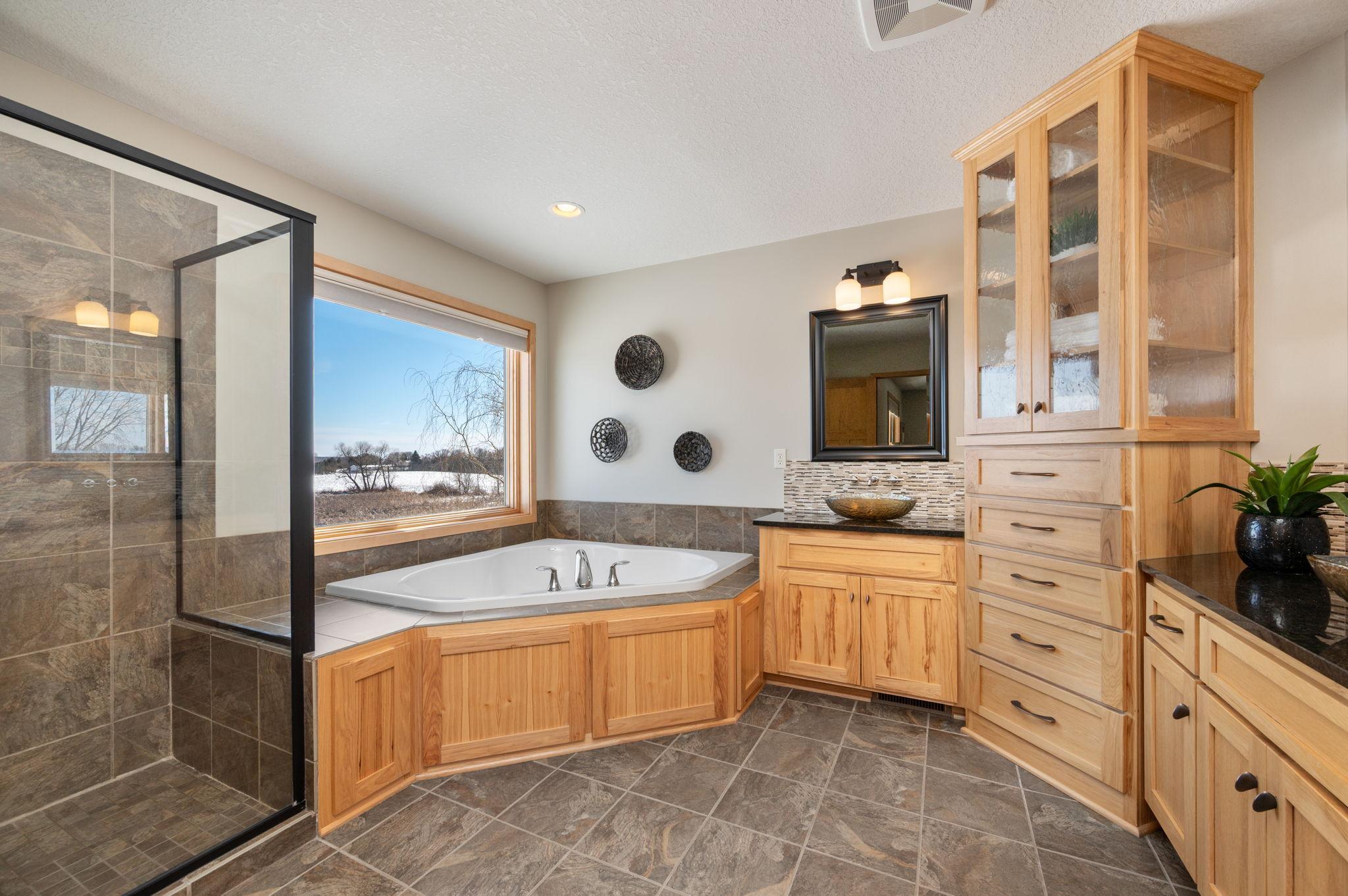 The primary bath features separate shower and whirlpool tub. Additionally, you have built-ins and separate designer sinks. The picture says it all!