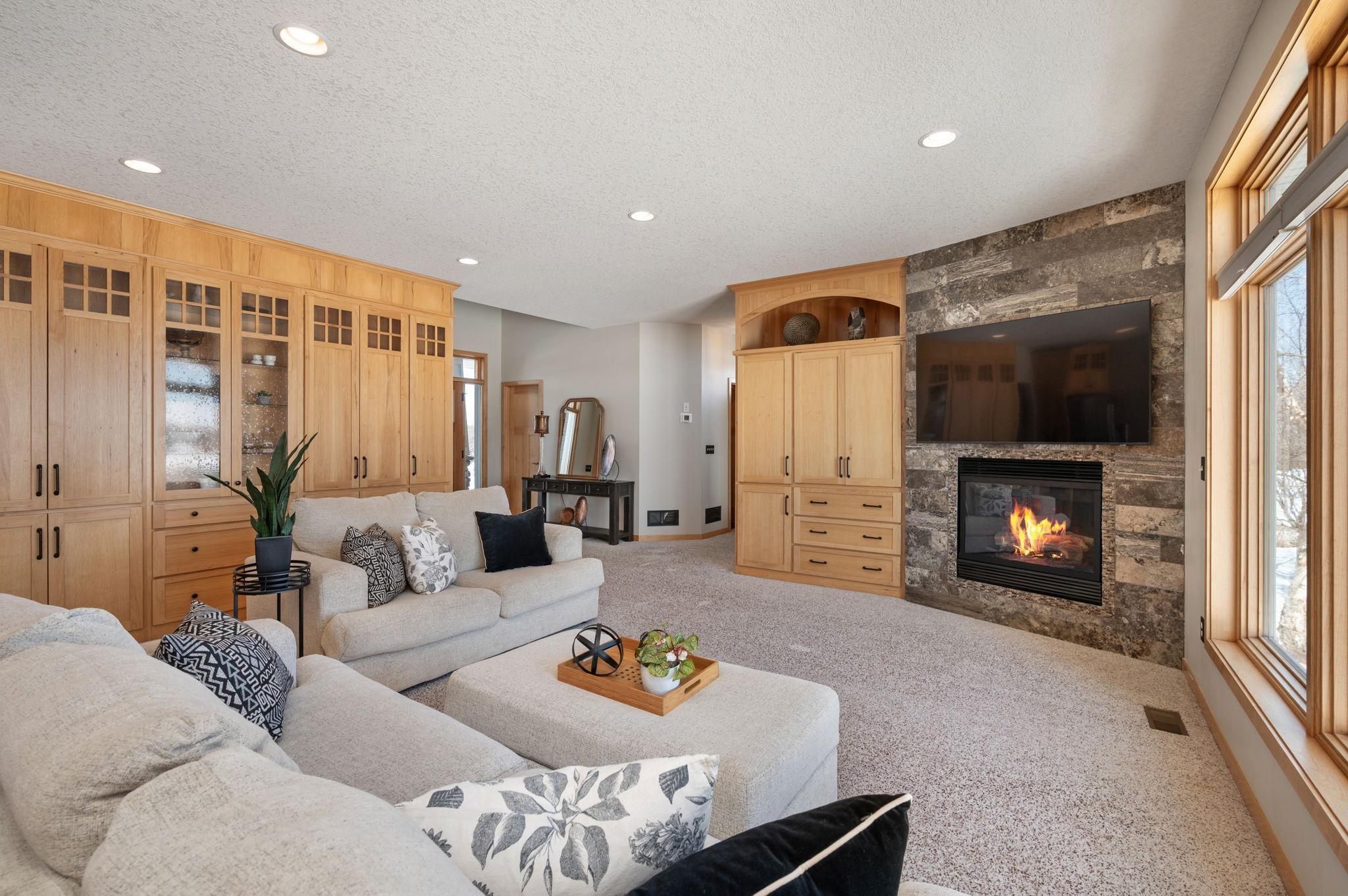 Main level great room with built ins for storage, gas fireplace and adjacent to the kitchen area