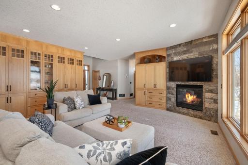 Main level great room with built ins for storage, gas fireplace and adjacent to the kitchen area