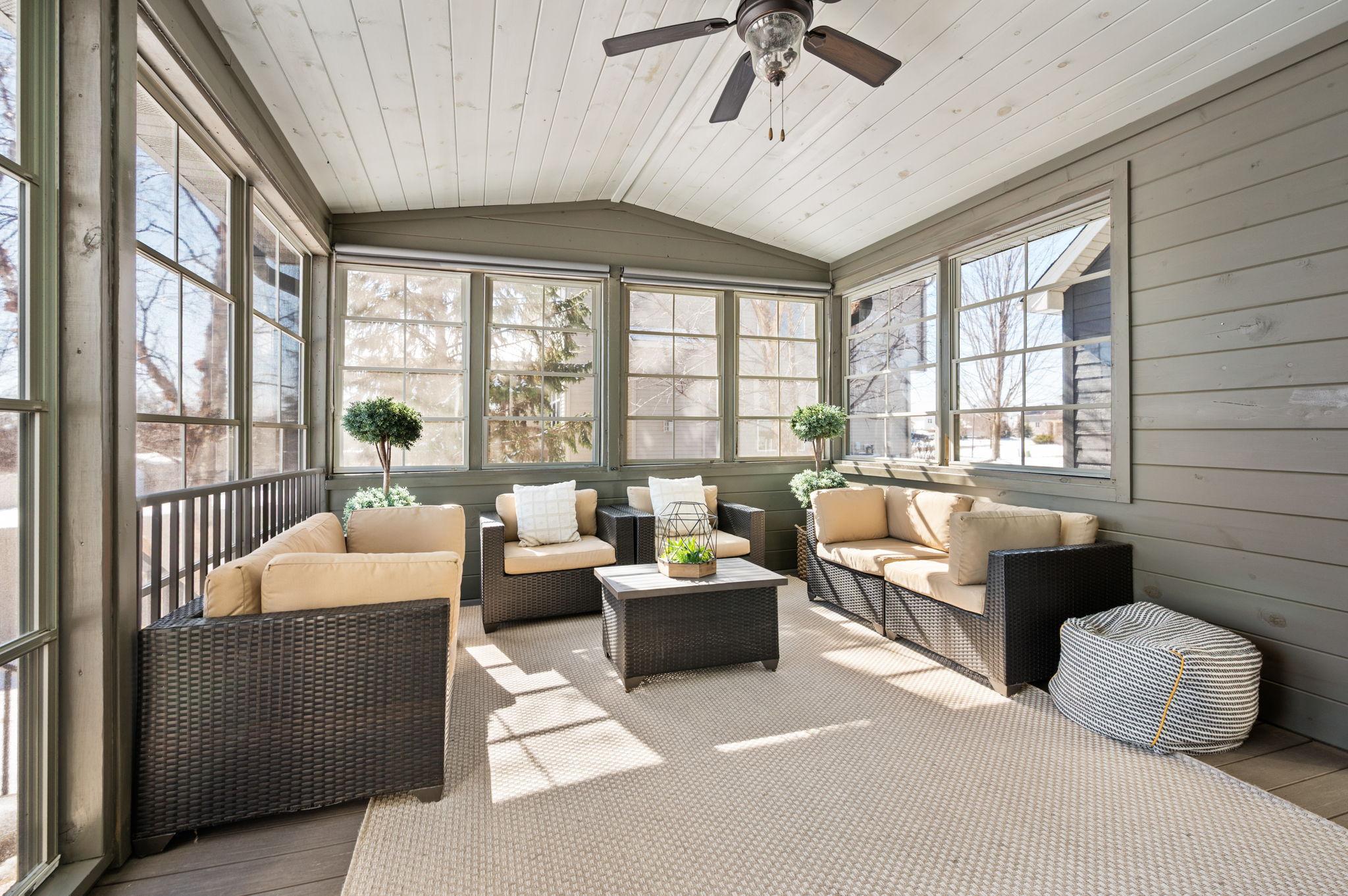 Vaulted 3 season porch is a great place to entertain and just enjoy! The door leading to the backyard does have room for your grill and steps to the backyard