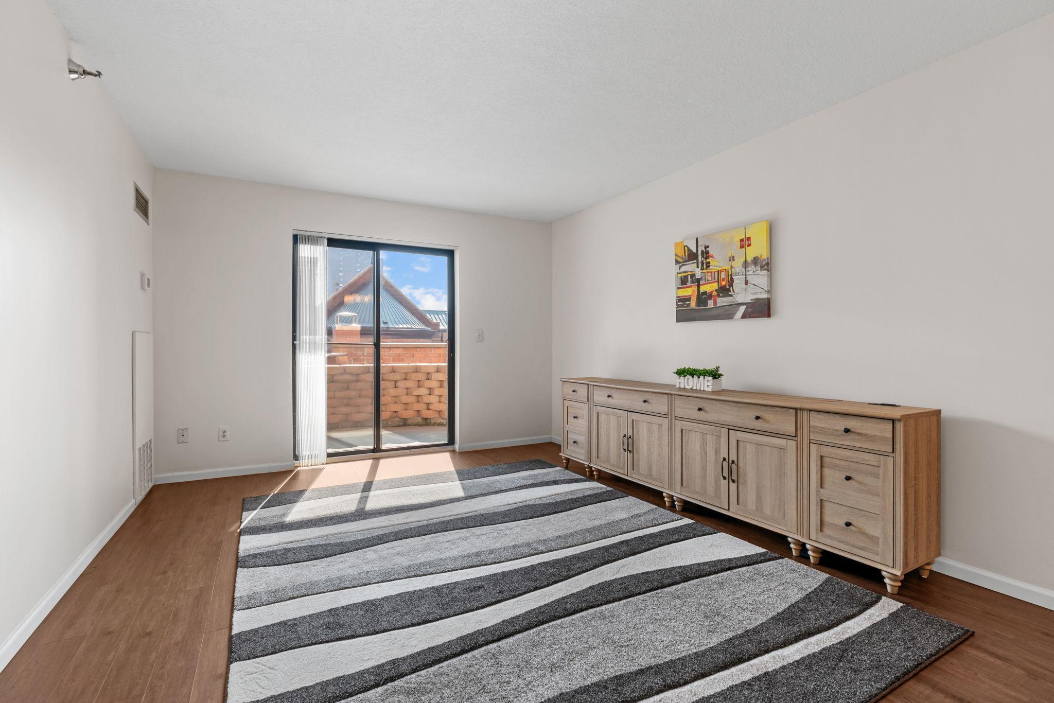 Living Room with LVP flooring, Sliding Patio Door with Views of Skyline