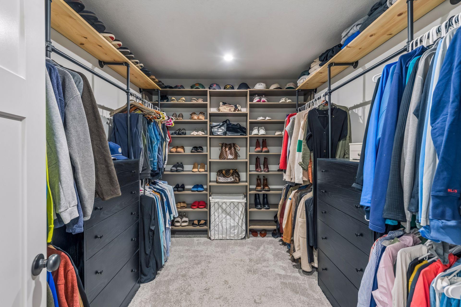 Wow! Look at this primary walk-in closet with custom shelving