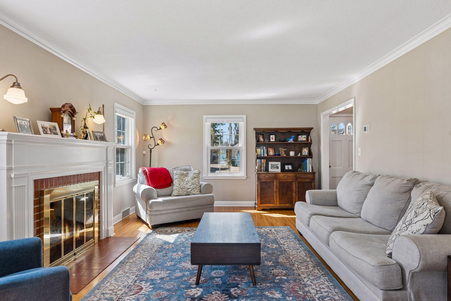 Lovely living room with wood burning fireplace and crown molding.