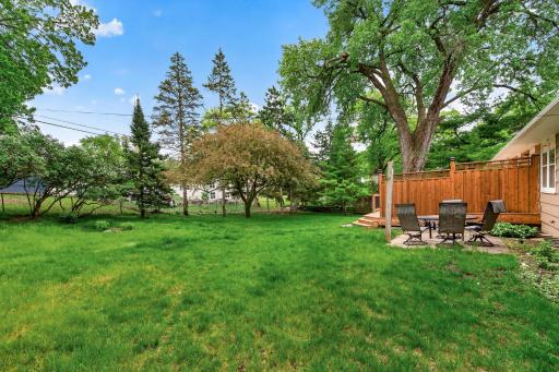 Private, tree-lined backyard with room to gather and unwind