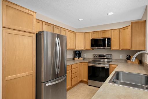 The kitchen features an abundance of cabinetry, countertop space and all new appliances.