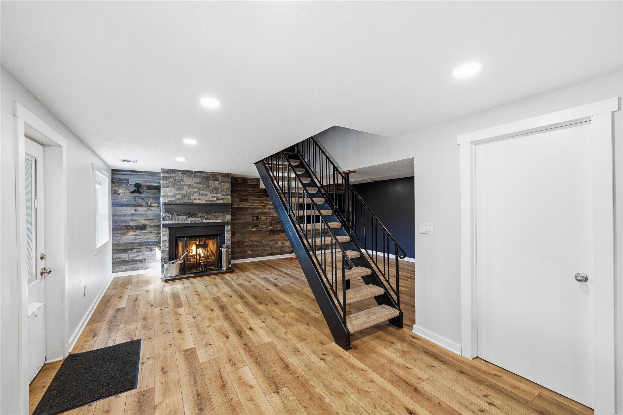 Spacious lower level family room with cozy wood-burning fireplace