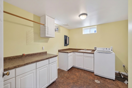 Ample laundry room provides a wash sink & plenty of counter/cabinet space.